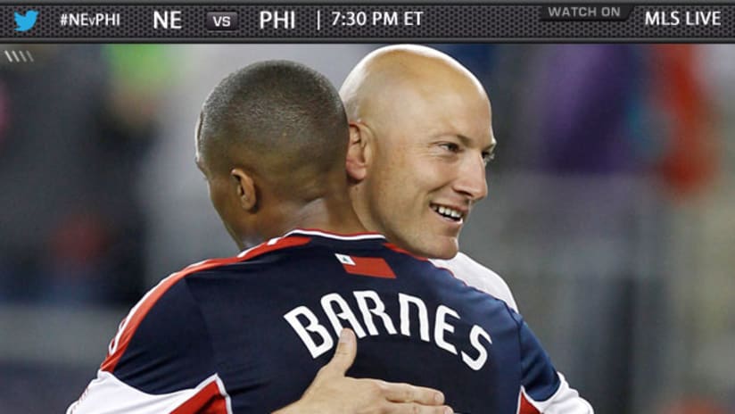 Darrius Barnes and Matt Reis hug eachother after playing in a soccer match.