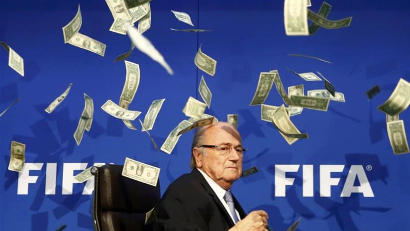 Sepp Blatter gets money thrown at him by comedian during FIFA press conference