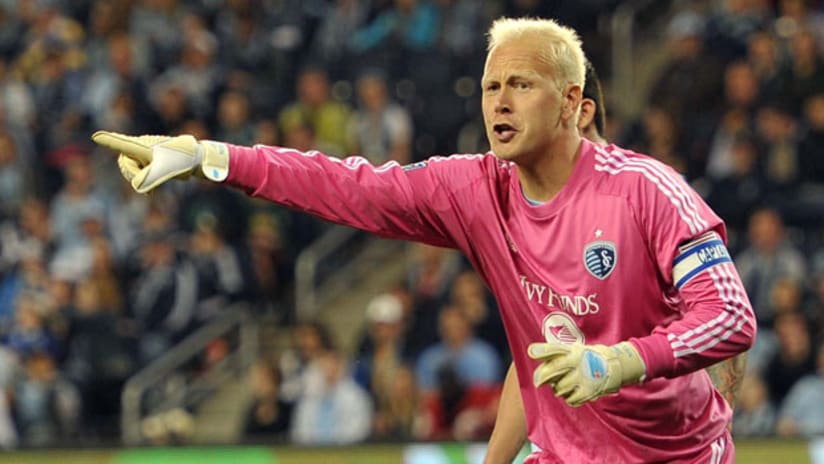 Jimmy Nielsen points to something while wearing armband