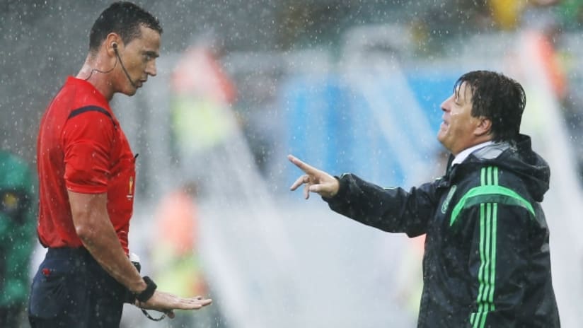 Mexico manager Miguel Herrera challenges referee Wilmer Roldan after a second disallowed goal in Friday's first half.