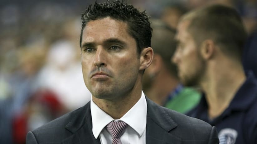 new england revolution manager jay heaps looks on as his side falls 3-0 to sporting