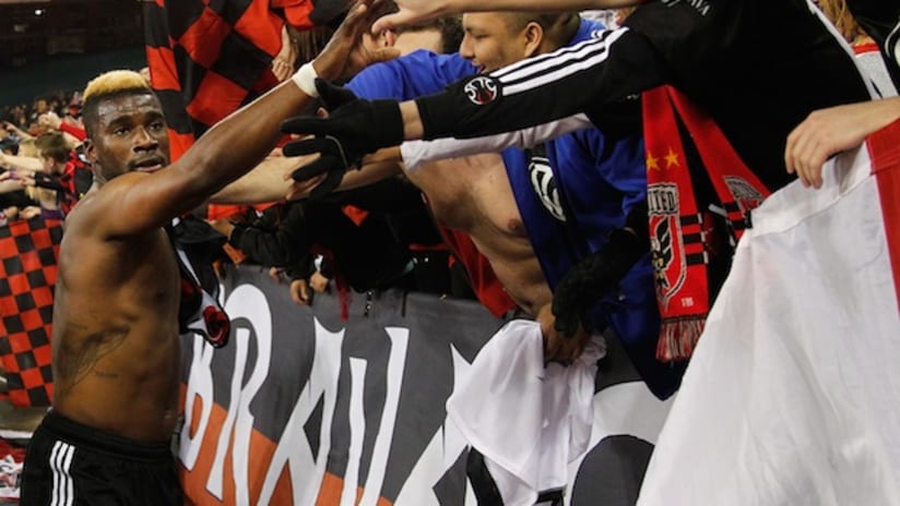 dc united's brandon mcdonald celebrates with fans after win over fc dallas