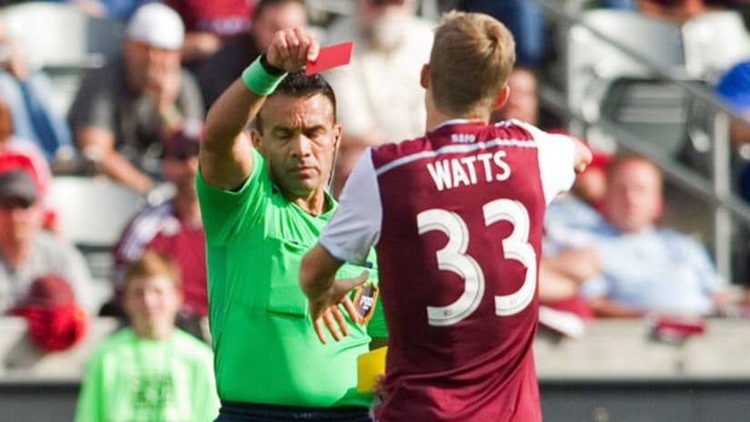 Colorado Rapids midfielder Jared Watts is shown a red card by referee Hilario Grajeda