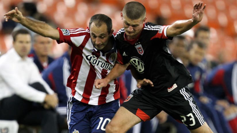 Chivas USA's Nick LaBrocca (left) and D.C. United's Perry Kitchen vie for possession.