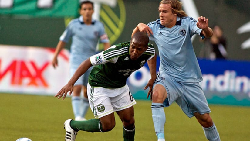 Timbers' Darlington Nagbe gets by Sporting's Chance Myers.