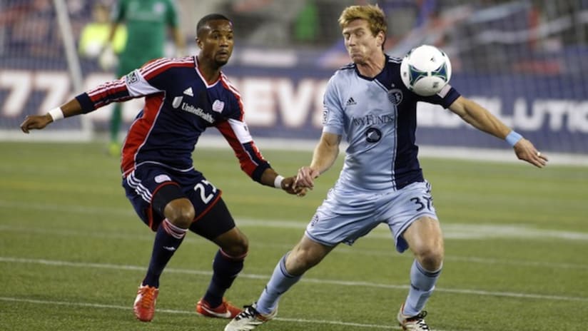 Darrius Barnes (New England Revolution) and Jacob Peterson (Sporting KC) battle for the ball