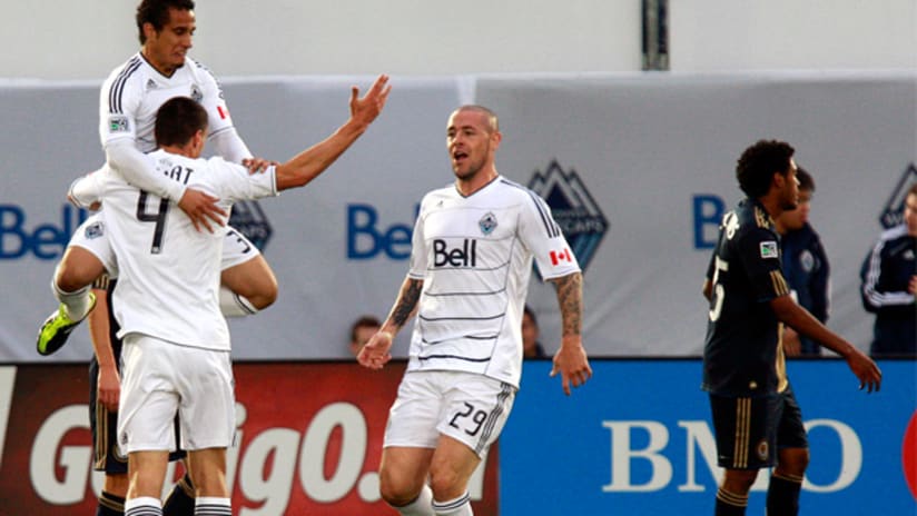 Vancouver's Alain Rochat celebrates his goal vs. Union with Camilo, Eric Hassli.