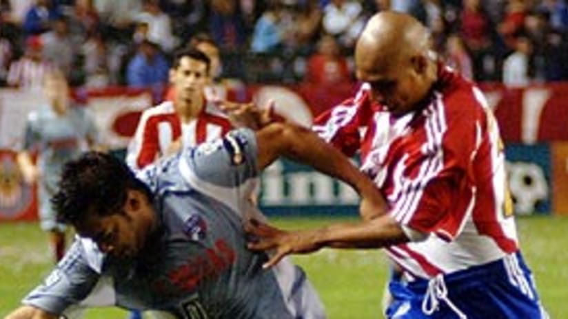 Douglas Sequeira (right) and Chivas USA couldn't keep Carlos Ruiz off the scoresheet.