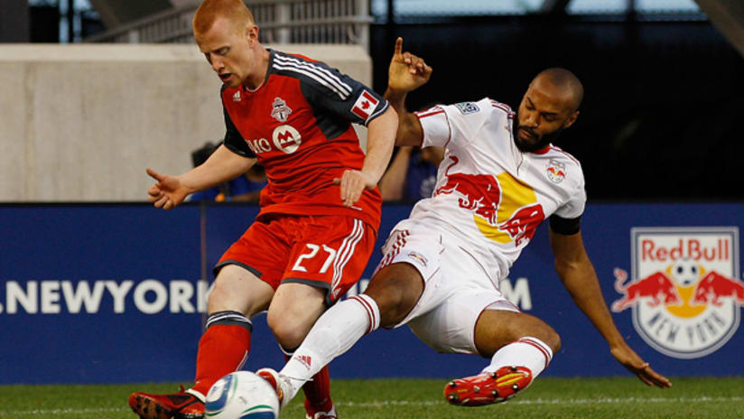 Richard Eckersley and Thierry Henry challenge for the ball