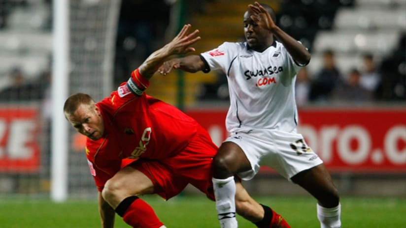 Febian Brandy, right, battles with Watford's Jay DeMerit while on loan at Swansea City.