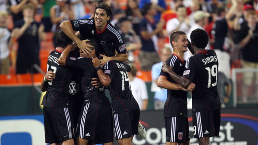 Members of D.C. United celebrate a goal against the Vancouver Whitecaps on Saturday.