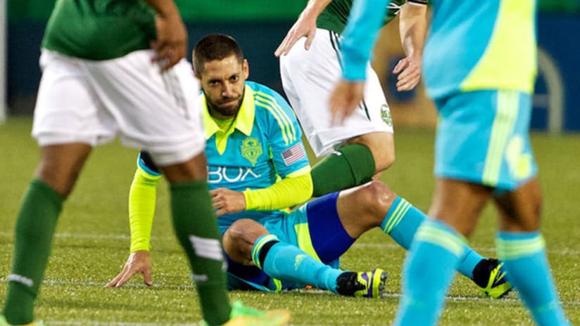 Clint Dempsey grimaces after suffering a shoulder injury in Portland