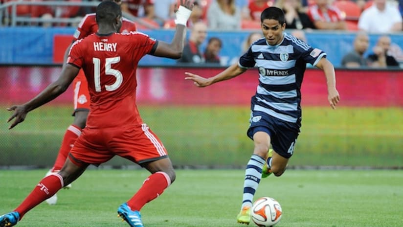 Igor Juliao of Sporting Kansas City takes on Doneil Henry of Toronto FC