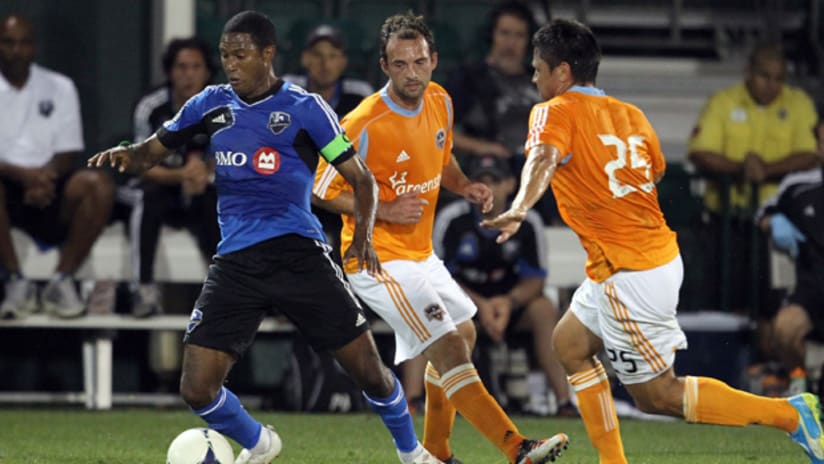 Patrice Bernier steers the ball away from two Dynamo players