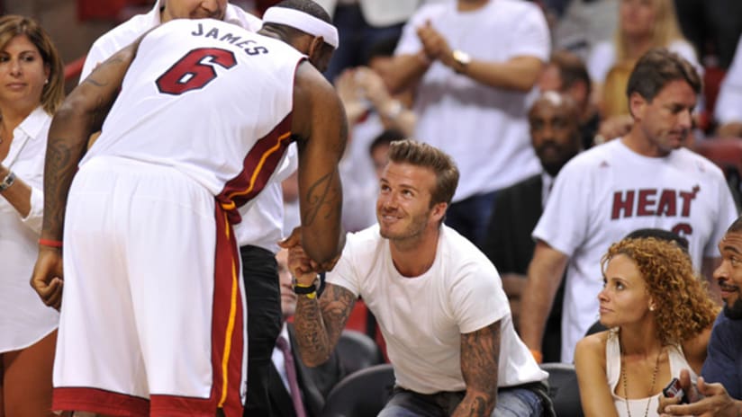 LeBron James and David Beckham shake hands at a Miami Heat game on June 3