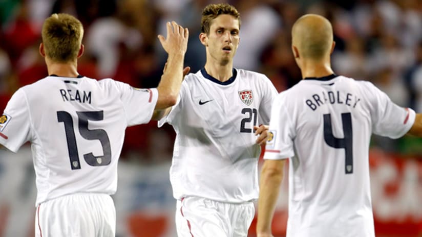 US players Tim Ream and Michael Bradley congratulate Clarence Goodson after his goal against Panama.