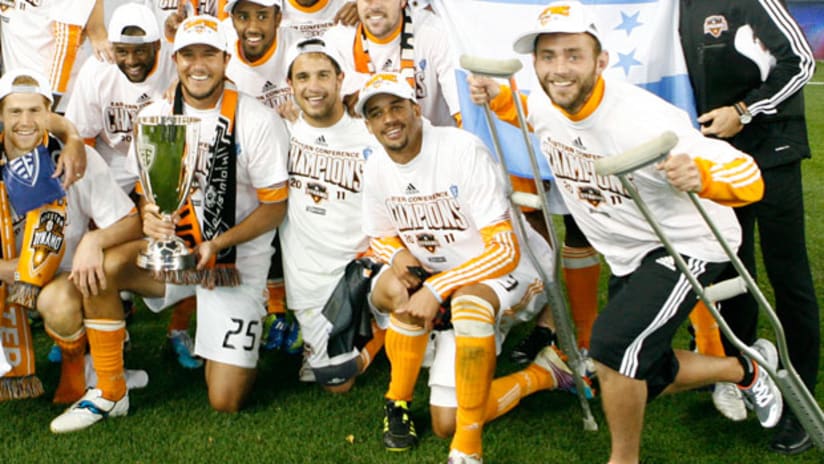 Dynamo celebrate Eastern Conference Championship with injured Brad Davis.