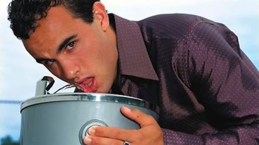 Landon Donovan drinks from a water fountain