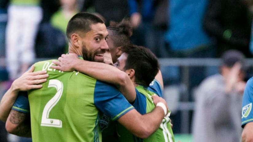 Clint Dempsey - Seattle Sounders - embraces teammates after a goal