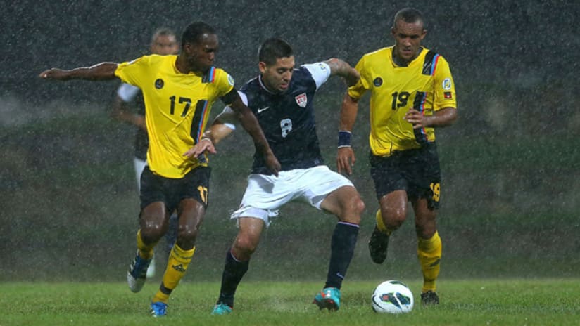 Clint Dempsey fights off two Antigua & Barbuda defenders