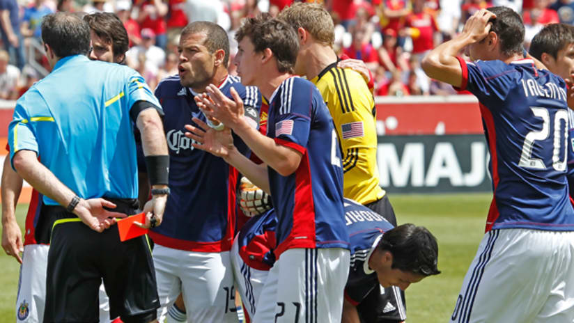 Chivas players surround the referee after teammate Marcos Mondaini is booked for a serious challenge on RSL's Javier Morales.