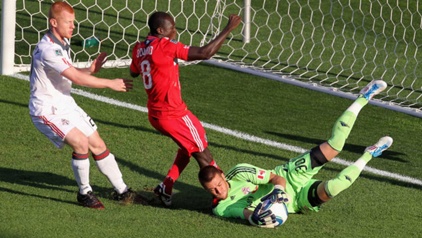 Milos Kocic makes a save in front of Dominic Oduro