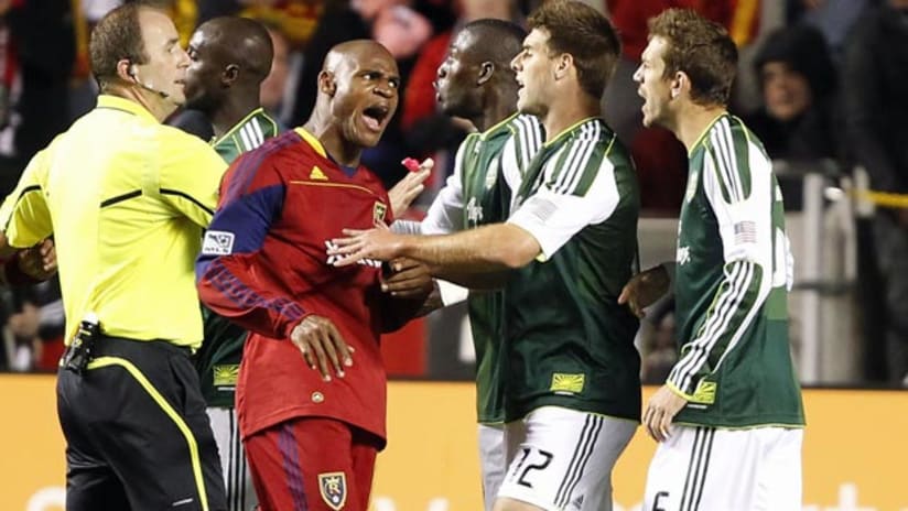 RSL's Jamison Olave jaws with Portland Timbers players, October 22, 2011.