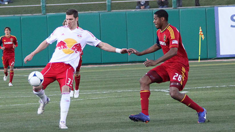 New York's Kenny Cooper is marked by RSL's Chris Schuler.