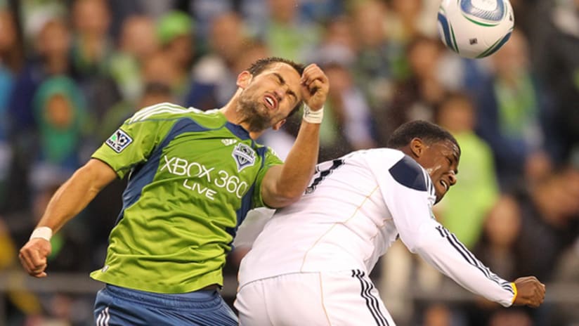 Seattle's Patrick Ianni (left) battles the Galaxy's Edson Buddle for a header during LA's 1-0 win on Sunday night at Qwest Field.
