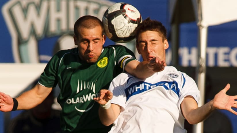 Portland's Ian Joy (left) battles Vancouver's Philippe Davies during the teams' 2-2 draw in Vancouver on Saturday.