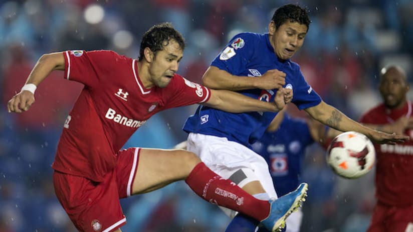 Toluca's Pablo Velazquez battles a Cruz Azul player in the CCL final