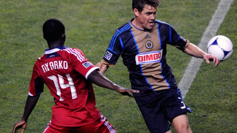 Union defender Chris Albright controls the ball as Fire midfielder Patrick Nyarko closes in.