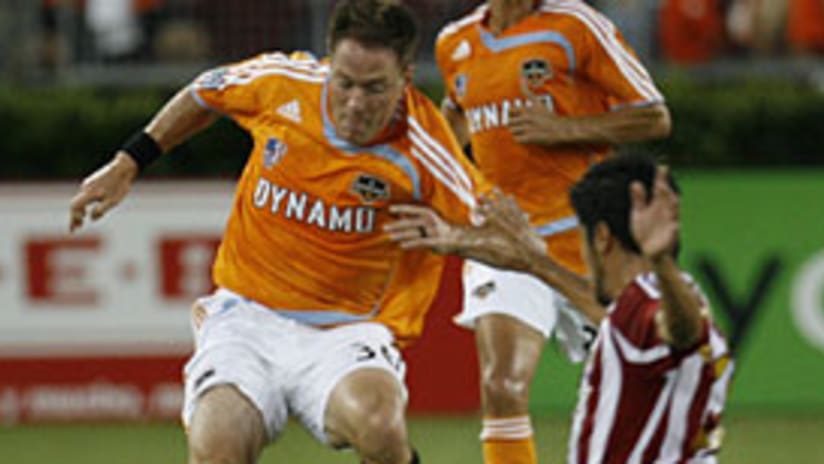 Paulo Nagamura (right) and the Chivas defense were not up to the task of slowing down the Houston attack.
