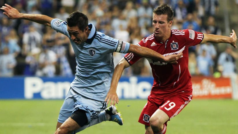 Chicago's Corben Bone (right) and Sporting's Davy Arnaud battle for the ball on Thursday at Livestrong Sporting Park.