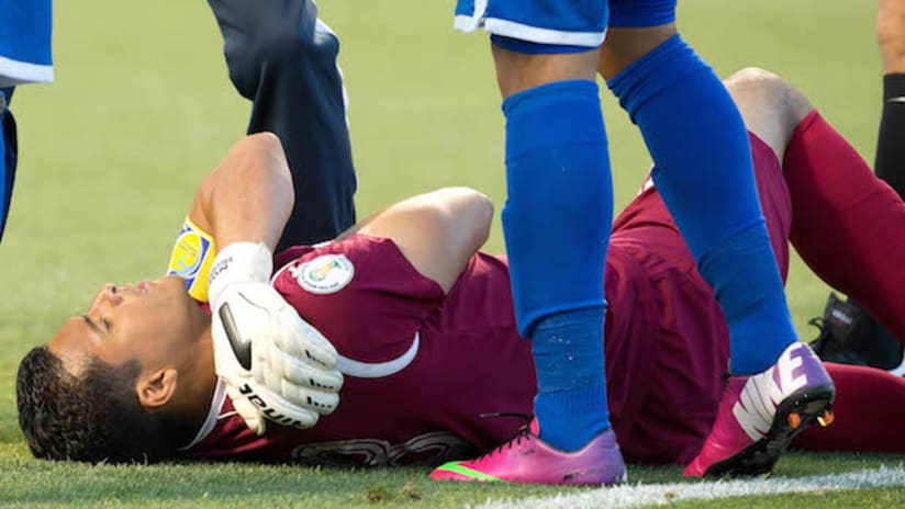 An injured Honduras player lies on the ground