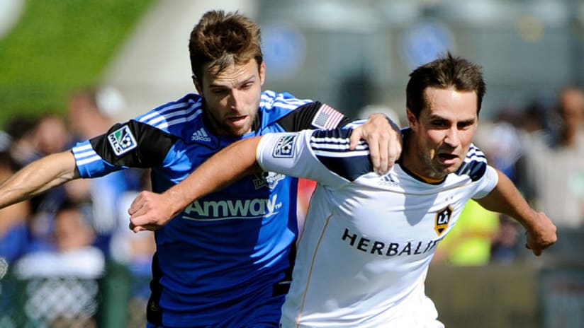 Todd Dunivant of the Los Angeles Galaxy fends off San Jose Earthquakes defender Bobby Convey.