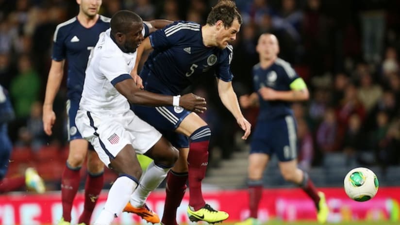Jozy Altidore battles for the ball with a Scotland player