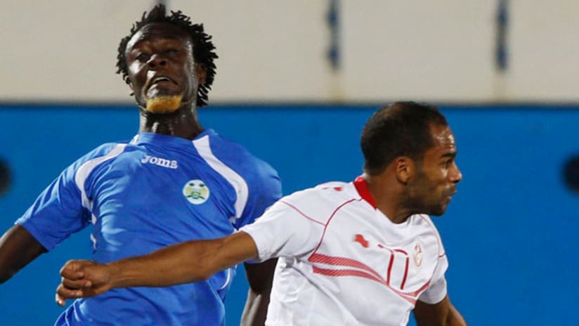 Kei Kamara, Sierra Leone, challenges Tunisia's Sabeur Kalifa in a World Cup qualifier, June 2013.