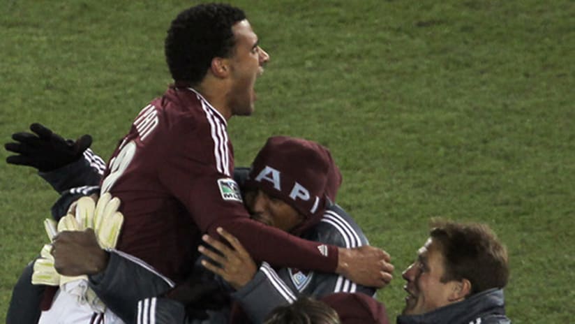 Andre Akpan leaps into the arms of his Colorado Rapids teammates after scoring his first MLS goal.