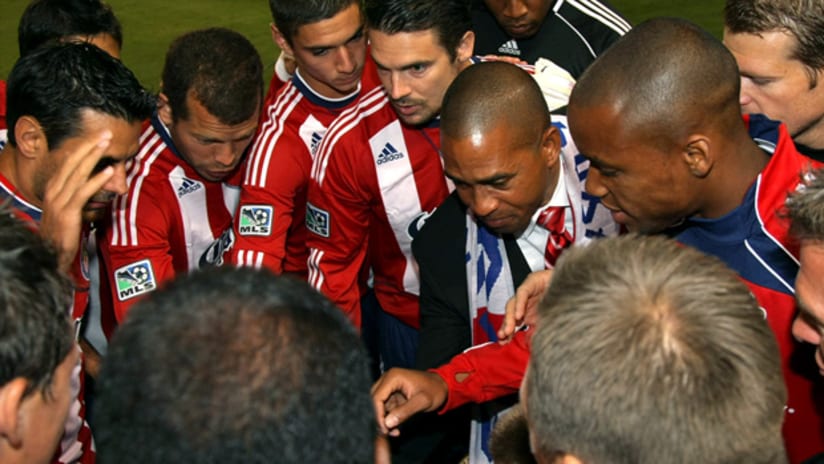Chivas USA players gather around head coach Robin Fraser.
