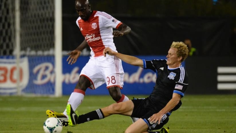 Steven Lenhart attempts a tackle on Futty Danso