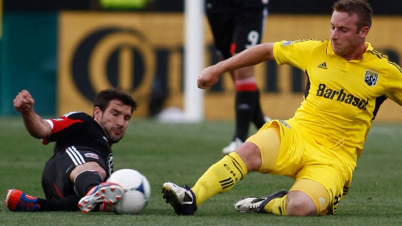 D.C. United's Chris Pontius and Columbus's Chris Birchall slide in for a loose ball, July 21, 2012.