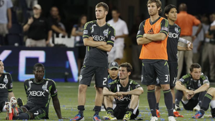 Seattle players are dejected after losing on penalties to Sporting KC