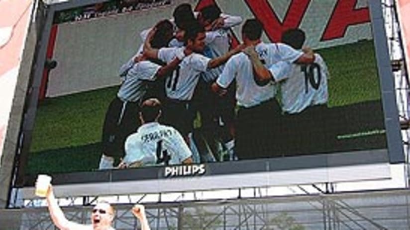An English supporter goes wild as the Three Lions celebrate a goal on the big screen in Frankfurt.