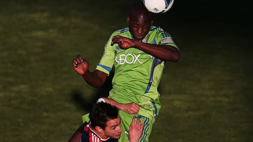 Djimi Traore, Seattle Sounders, outjumps Diego Fagundez, New England Revolution, at the 2013 Desert Diamond Cup.