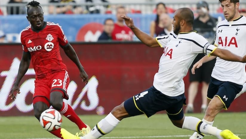Dominic Oduro challenges Tottenham's Younes Kaboul in an international friendly