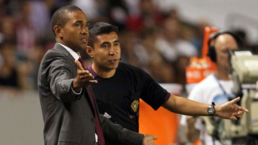 Chivas USA head coach Robin Fraser confers with the fourth official