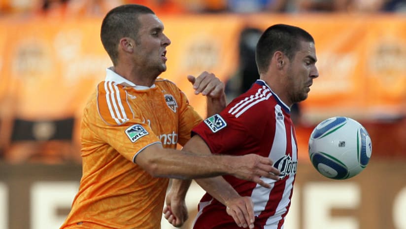 Will Bruin of the Houston Dynamo and Heath Pearce of Chivas USA battle for possession.