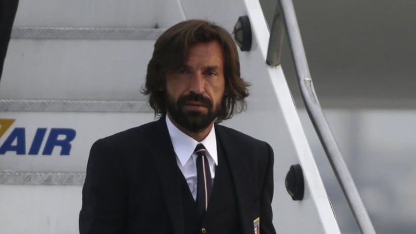 Andrea Pirlo deplaning in a suit