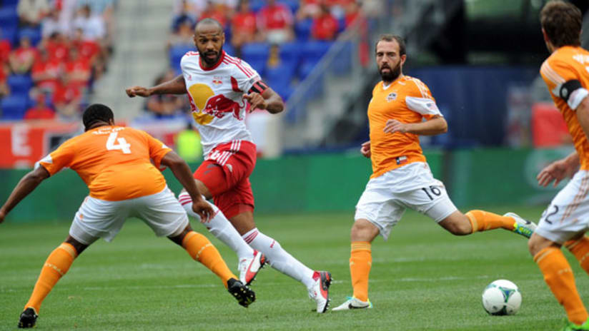 Thierry Henry advances the ball on Houston's Jermaine Taylor and Adam Moffat